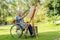 Front view of Asian senior man sit on wheelchair and paint the painting outdoor for relax and revive good health of old people