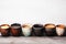 Front view assorted coffee cups on a wooden table background with copy space