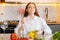 Front view of attractive cheerful young redhead woman eating fresh vegetarian salad enjoying fresh tasty vegetables with