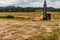 Front view of backhoe siting idle at construction site