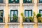 Front view of beautiful decorative balconies with green plants on an old building in Malaga, Spain