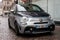 Front view  of bicolor grey and blue Abarth car 595 parked in the street by rainy  day
