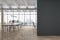 Front view on blank black wall in light eco style office with stylish workspaces, modern computers, wooden parquet floor, white