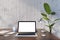 Front view on blank white modern laptop screen with empty space on brown wooden table with notebooks and coffee cup on light