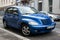 Front view of blue Chrysler Cruiser parked in the street