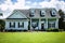 Front View of blue house with siding in the suburbs