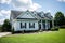 Front View of blue house with siding in the suburbs