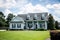 Front View of blue house with siding in the suburbs