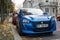 Front view of blue Peugeot 208 electric parked in the street