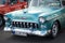 Front view of blue vintage Chevrolet convertible parked in the street