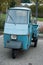 Front view of blue vintage piaggio tricycle parked in the street