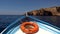 Front view boat with lifebuoy,floating on blue sea.