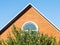 Front view of brick gable wall and blue sky