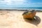 Front view of a broken canoe over the sand