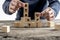 Front view of a businessman arranging wooden cubes in a structure reading Start up