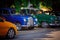 Front view of classic retro vintage cars standing in dark shadows under the trees