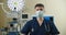 Front view close up of a Caucasian surgeon male healthcare worker in a hospital putting on a surgical mask.Healthcare