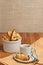 Front view, close up of homemade, freshly baked, apricot walnut biscotti and cup of espresso on a round, small, white saucer with