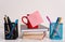 Front view coffee cup mug hot drinks blank colored sticky note stacked piled books pen metal holders lying retro vintage