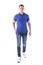 Front view of confident young adult man walking forwards and looking at camera in blue polo shirt.