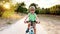 Front view of cute little boy riding a bicycle