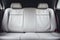 Front view of elegant white leather back passenger seats in a state of the art modern luxury car