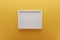 Front view of empty white picture frame on wall, background light orange, minimal design concept, 3D render