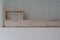 Front view of empty wooden shelf above over the bathtub.