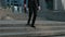 Front view feet of businessman commuting to work. Confident guy in leather shoes and a suit walks along the street of