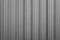 Front view of gray ribbed metal surface on fence or wall for backdrop