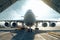 Front view from the ground of a cargo plane at the airport. Loaded transport aircraft is taxing from the cargo terminal