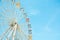 Front view of half retro colorful ferris wheel at amusement park over blue sky background, copy space, vintage effect