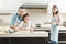 front view of happy caucasian family in flour making dough