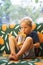 Front view of happy thirsty blond kid boy drinking lemonade, fruit tea, kombucha ice tea with peach and lemon, wellness