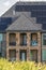 Front view of home with porch spiral stairs balcony and solar panel on the roof