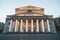 Front view of illuminated facade of Bolshoi Theater. A down-top view of white columns and grand top of Big Theatre in Moscow.