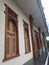 Front view of the Indonesian traditional house with a row of windows made of teak