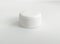 Front view of isolated white plastic round screw cap. Close up of the cap of the plastic bottle
