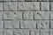 Front view of light gray unpainted brick veneer wall