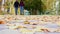 Front view of a loving couple walking in the autumn park at daytime. Close-up of romantic young loving couple walking in