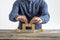 Front view of a man making a bridge with wooden cubes