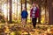 Front View Of Mature Retired Couple Walking In Fall Or Winter Countryside Using Hiking Poles