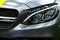 Front view of a Mercedes Benz C 63s AMG coupe. Front Headlight. dark Matt colour .Car exterior details