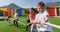 Front view of mixed-race schoolkids playing tug-of-war in the school playground 4k