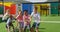 Front view of mixed-race schoolkids playing tug-of-war in the school playground 4k