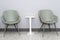 Front view of modern  simple chairs with white table against grey wall in a minimal style  waiting room interior. Chairs in