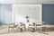 Front view on modern wooden chairs around white table in light dining room with stylish chandelier on top