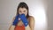 Front view of a muscular girl with sports bandages on her arms doing boxing workout. Young sportswoman workout movement