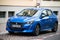 front view of new blue Peugeot 208 parked in the street