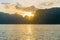 Front view of the ocean in the morning the sun was rising, reflections fell on the smooth calm surface with golden warm light.